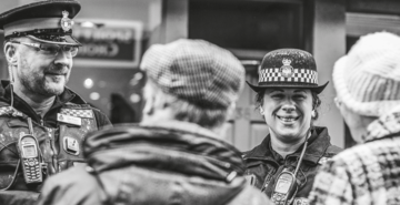 Sussex police officers smiling at an older couple